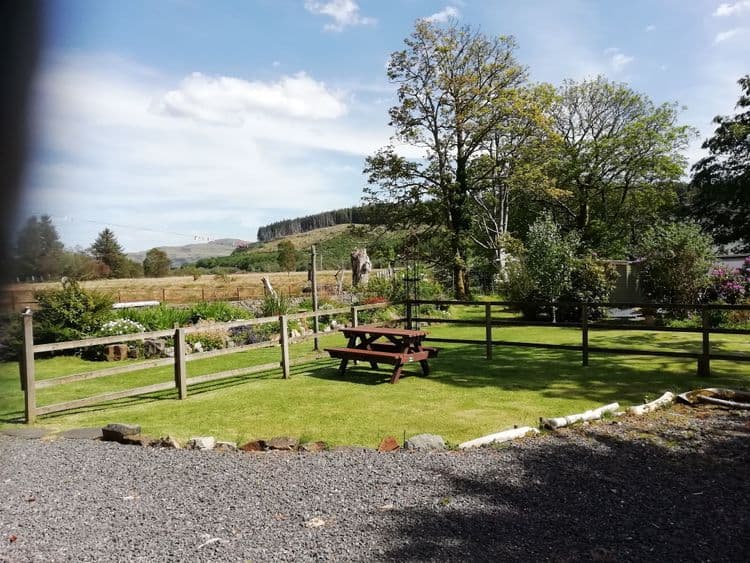 cottage picnic table and view over fields.